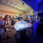 people in costume playing arcade games
