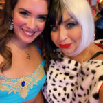 two women in costume smiling at the camera